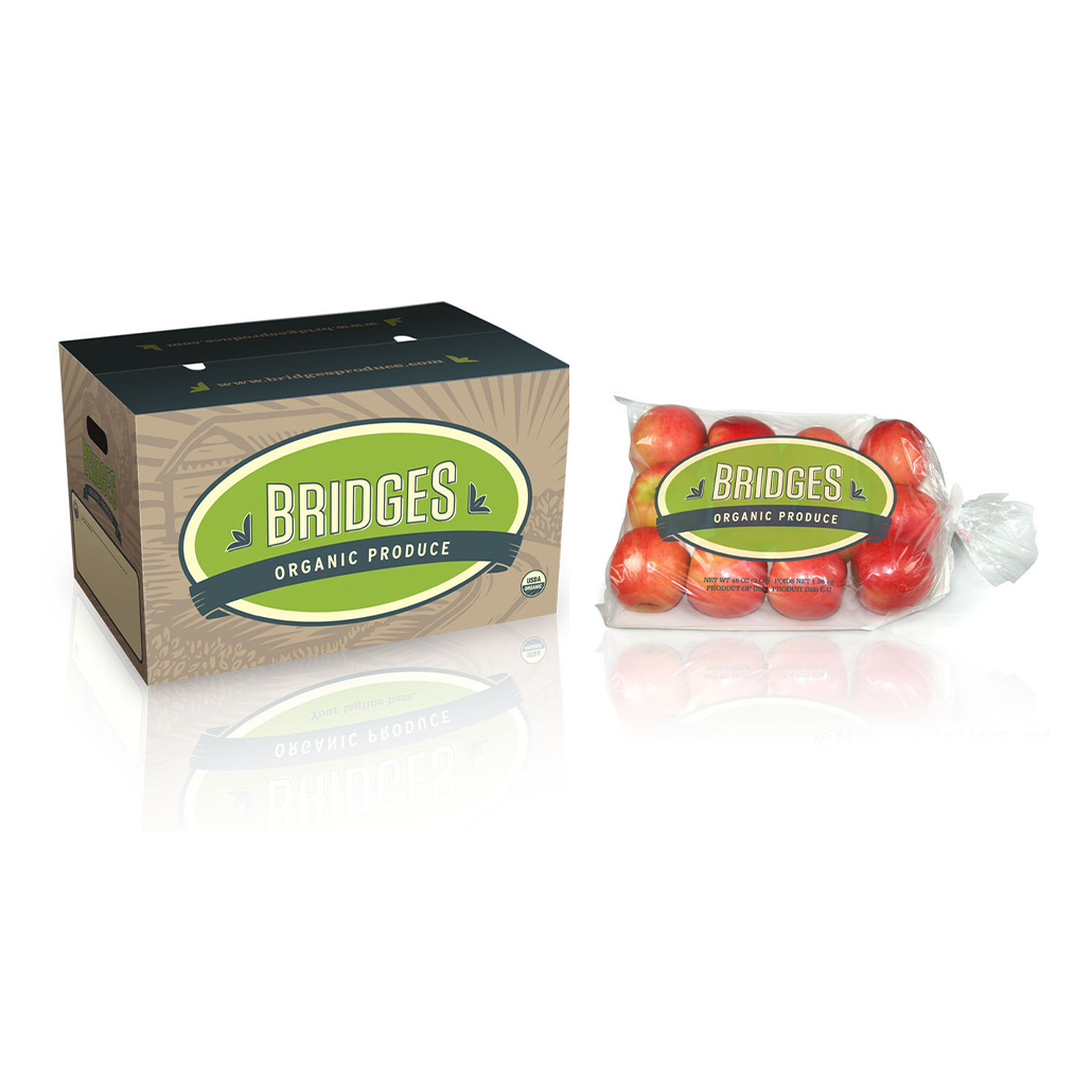 Bridges Organic Produce packaging with a rustic box and clear poly bag filled with fresh, organic apples, emphasizing eco-friendly design and sustainable produce.